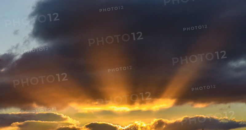 Sunbeams break out from sunset cloud formation. Leura, New South Wales, Australia