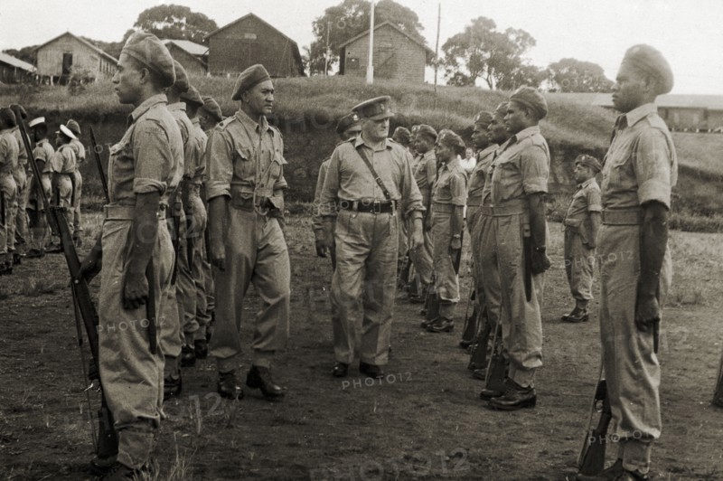 Colonel Magrane inspects a Fijian regiment. Colonel J P Magrane inspects a regiment of uniformed servicemen in the Fiji military forces. The soldiers comprise a contingent that were due to take part in a victory parade in London on 8 June 1946. Fiji, 1946. Fiji, Pacific Ocean, Oceania.