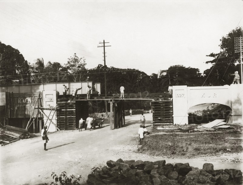 Building a rail bridge. A rail bridge under construction on the Kilindini-Mombasa road. The bridge's construction was overseen by Parlane Macfarlane, a senior British employee of the Kenya & Uganda Railways. The date '1927' is engraved on one of the masonry pylons. Mombasa, Kenya, 1927. Mombasa, Coast, Kenya, Eastern Africa, Africa.