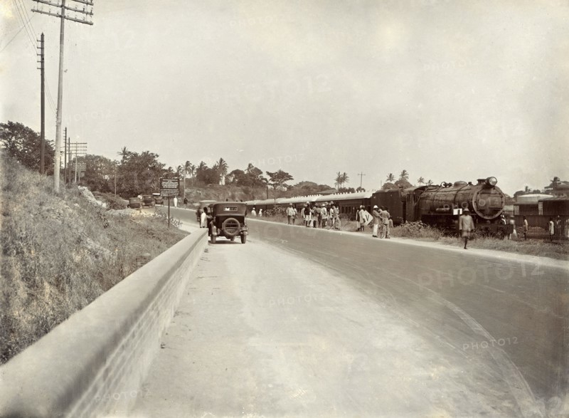 Steam train at a rail siding. View from the road of a steam train, the 'Laconia Special', at a rail siding. Mombasa, Kenya, circa 1930. Mombasa, Coast, Kenya, Eastern Africa, Africa.