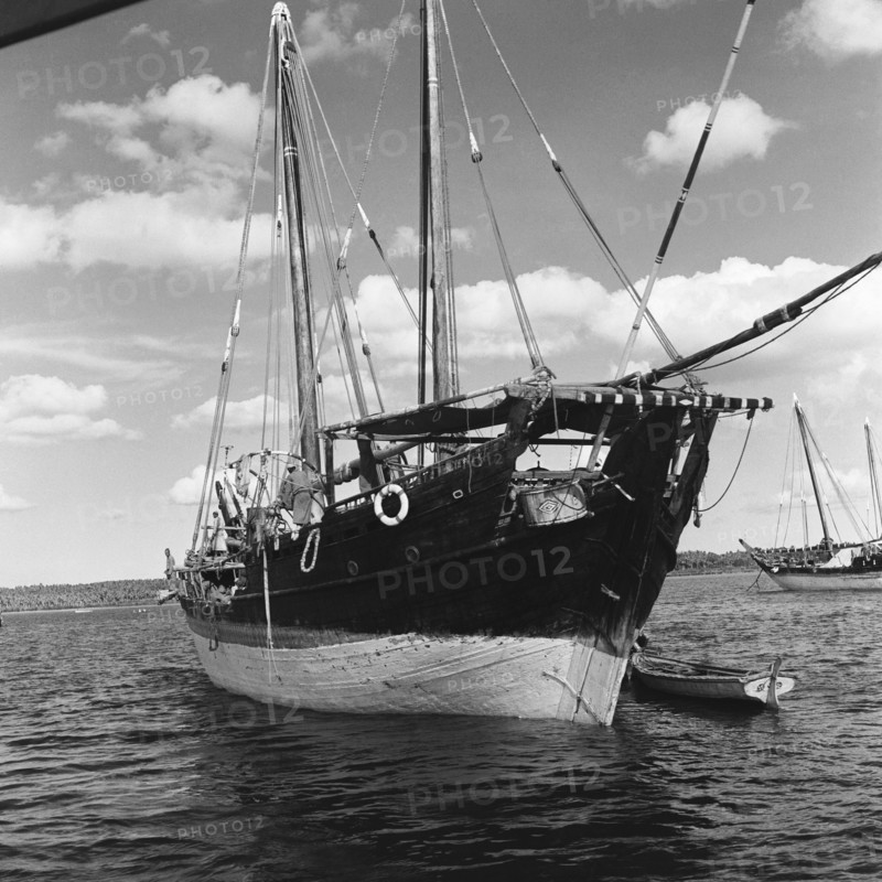 Dhow in a harbour. A dhow in a harbour off the coast of Zanzibar (now Tanzania) in the Indian ocean. Zanzibar (Tanzania), 3-12 March 1953., Zanzibar Central/South, Tanzania, Eastern Africa, Africa.