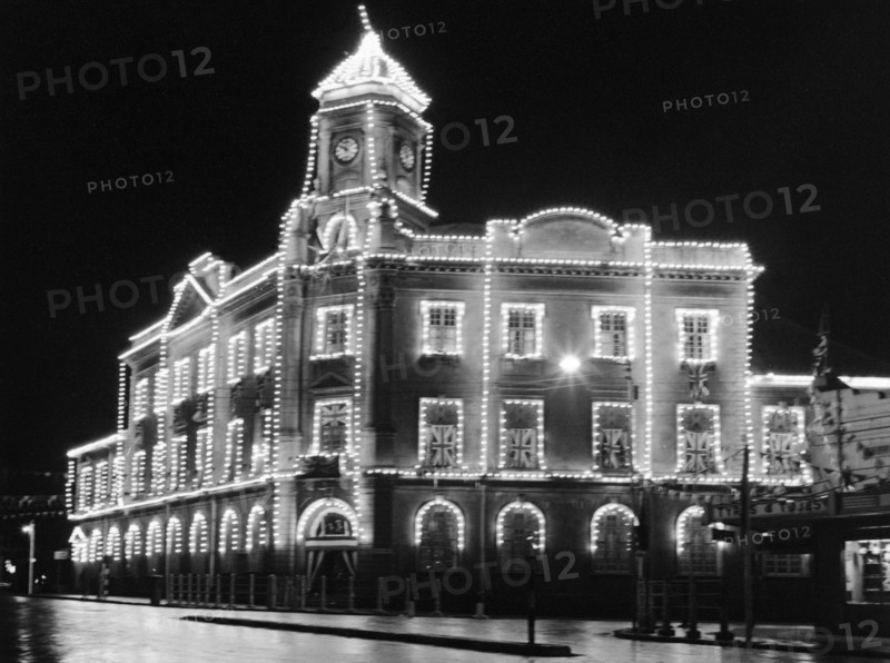 Khoja Mosque. The Khoja mosque, on the corner of Government Road (now Moi Avenue) and Swamp Road, illuminated with strings of electric lights and festooned with union jack flags. Nairobi, Kenya, circa 1956.