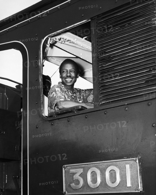 Julius Nyerere in the driver's seat. A publicity photograph from the East African Railways and Harbours Administration (EAR&H) shows Dr Julius Nyerere, the first leader of independent Tanganyika, sitting in the driver's seat of train, engine number 3001. Tanganyika (Tanzania), circa 1961. Tanzania, Eastern Africa, Africa.