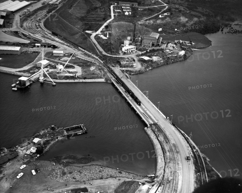 Kipevu Bridge. An aerial publicity photograph from the East African Railways and Harbours Administration (EAR&H) records the passage of the first passenger train over the Kipevu bridge, linking Mombasa Island with the Kenyan mainland. Mombasa, Kenya, 12 August 1960. Mombasa, Coast, Kenya, Eastern Africa, Africa.
