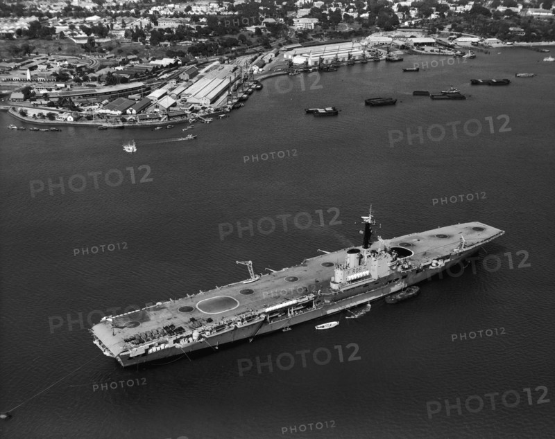 HMS Bulwark in Kilindini harbour. An aerial publicity photograph from the East African Railways and Harbours Administration (EAR&H) showing the British aircraft carrier, HMS Bulwark, in Kilindini harbour. Mombasa, Kenya, 25 August 1960. Mombasa, Coast, Kenya, Eastern Africa, Africa.