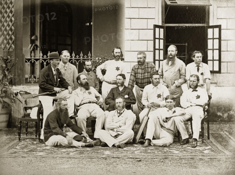 Members of the south Bombay cricket team. Group portrait of members of the south Bombay cricket team dressed in their whites outside a colonial-style buidling. Bombay (Mumbai), India, circa 1875. Mumbai, Maharashtra, India, Southern Asia, Asia.