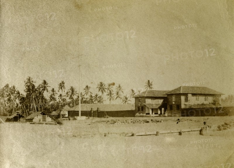 Custom House, India. A Kerala Custom House surrounded by palm trees on the beach. Calicut, India, circa 1910. Calicut, Kerala, India, Southern Asia, Asia.