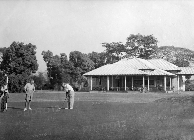 Playing golf, Rangoon. Golfers practice their putts outside the newly opened club house at the Rangoon Golf Club. Rangoon (Yangon), Burma (Myanmar), circa 1952. Yangon, Yangon, Burma (Myanmar), South East Asia, Asia.