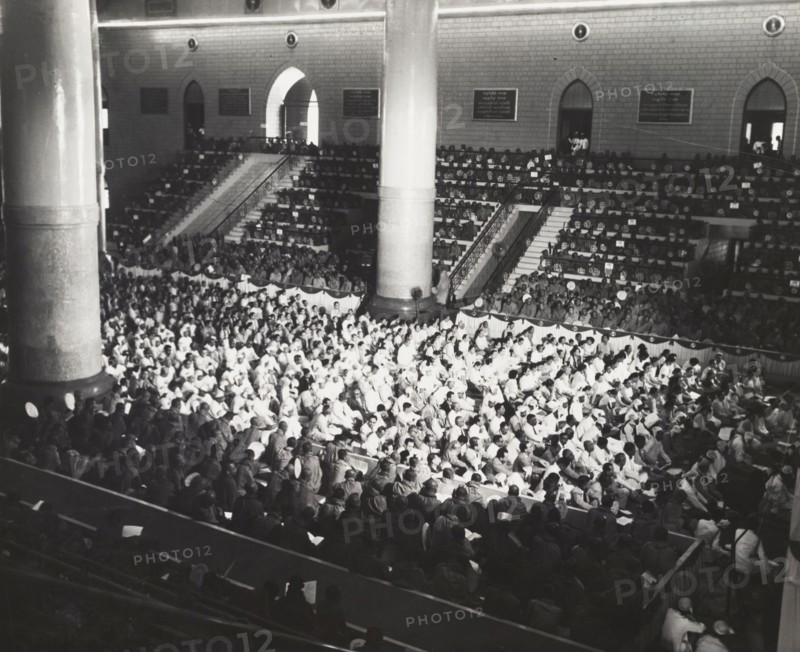 The congregation at the sixth Buddhist Synod. A Buddhist congregation packs out a large hall during the sixth Buddhist Synod in Rangoon. The event was attended by 2,500 Buddhist monks from throughout southern Asia. Rangoon, Burma (Yangon, Myanmar), 1954. Yangon, Yangon, Burma (Myanmar), South East Asia, Asia.