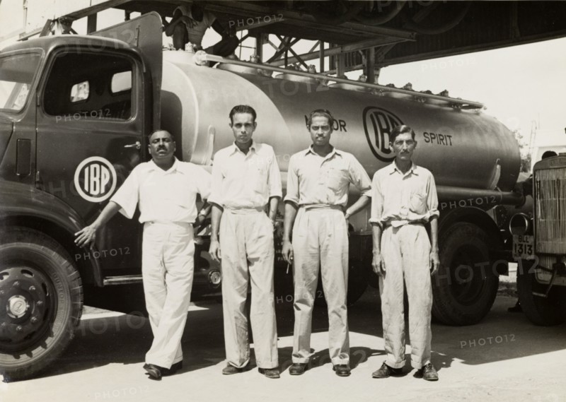 Indo-Burma Petroleum Company tanker. Four uniformed Burmese workers pose for a photograph in front of an Indo-Burma Petroleum Company petrol tanker. Burma (Myanmar), circa 1942. Burma (Myanmar), South East Asia, Asia.