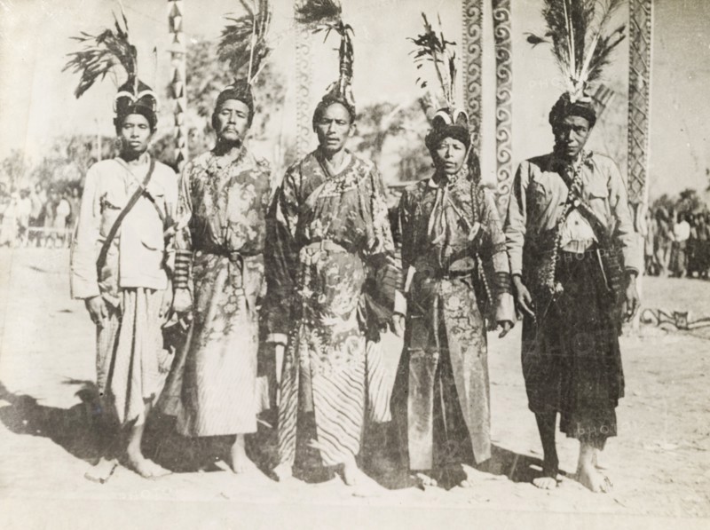 Five Asian men in ceremonial dress. Portrait of five Asian men, dressed in ceremonial attire including embroidered robes and elaborately feathered headdresses. Probably Burma (Myanmar), circa 1905. Burma (Myanmar), South East Asia, Asia.