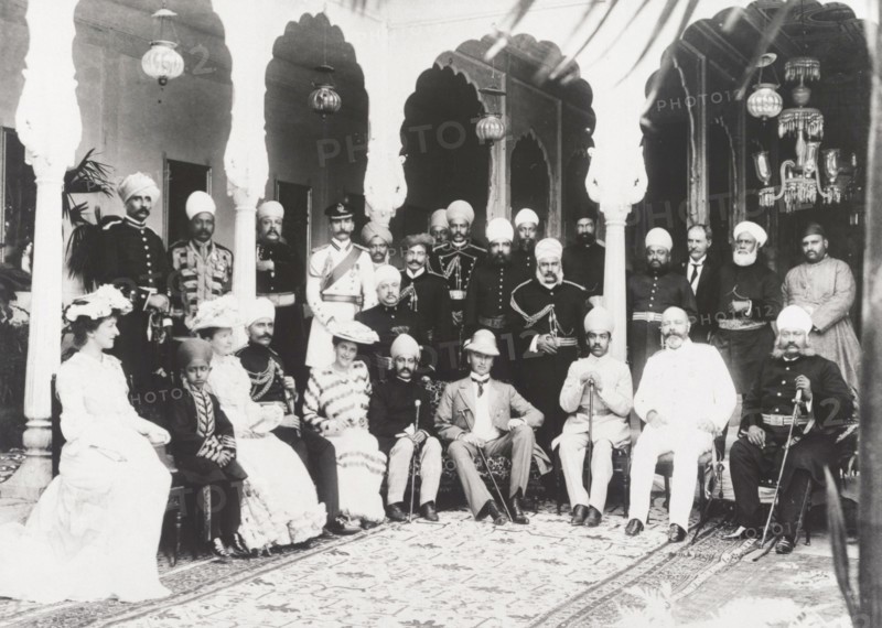 British and Indian officials at the Maharajah's palace. Indian and British officials pose for a group portrait inside a room at Maharajah Peishkar's palace. Guests include Marquess Curzon of Kedleston (1859-1925), Viceroy of India between 1899 and 1905, and Mahbub Ali Khan (1869-1911), Nizam of Hyderabad State. Hyderabad, India, 1902. Hyderabad, Andhra Pradesh, India, Southern Asia, Asia.