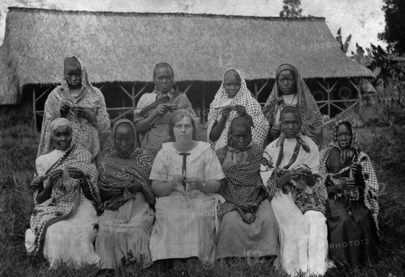 Women knitting. Group portrait of Mrs Charles Bungey and nine African women, most of whom are knitting or doing crochet work. The African women are heavily clothed, with long dresses and head shawls or scarves. Athi Plains near Nairobi, British East Africa (Kenya), August 1912., Nairobi Area, Kenya, Eastern Africa, Africa.