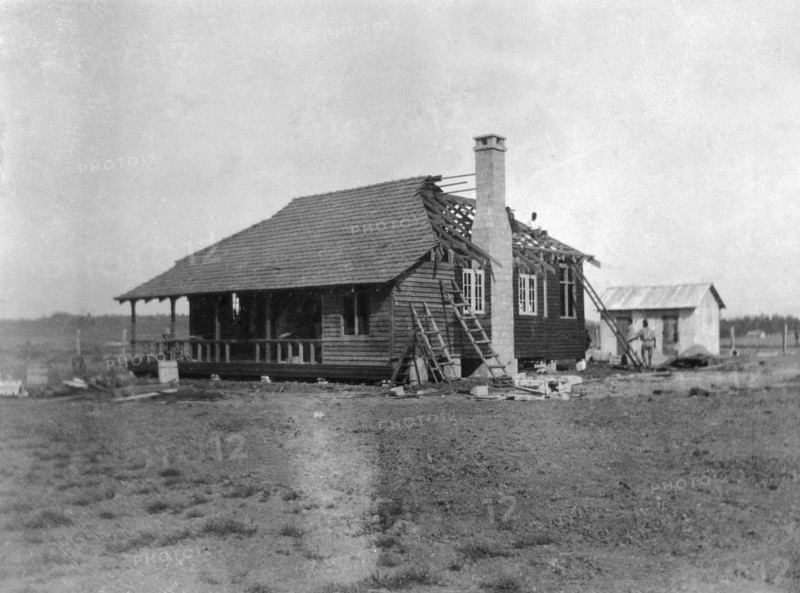 Building a house. This is the third in a series of four photographs showing the rapid erection of a timber-framed European-style house. The house was built for Charles Bungey, a training officer with the Kenyan Public Works Department, by the local apprentices of his department. Nakuru, Kenya, March 1922. Nakuru, Rift Valley, Kenya, Eastern Africa, Africa.