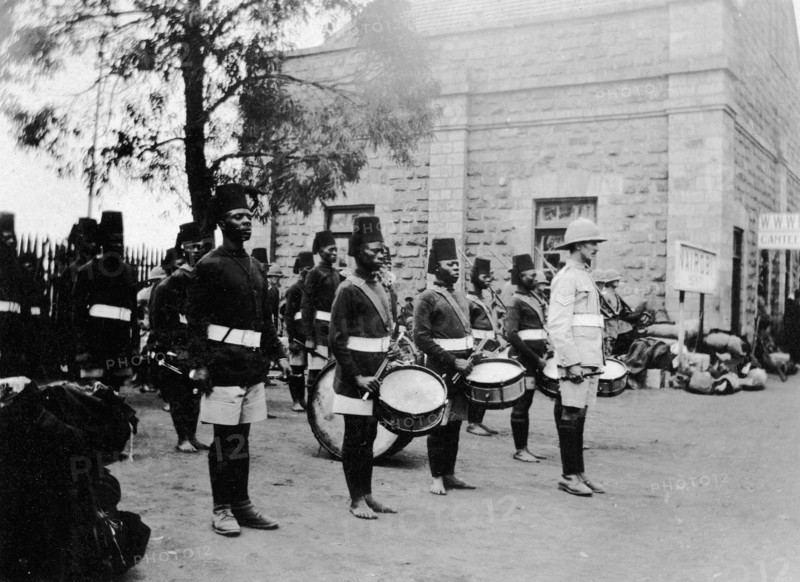The band of 2/2nd King's African Rifles. A European officer stands at the front of several rows of uniformed African drummers and buglers at Nairobi railway station. Nairobi, British East Africa (Kenya), 1917. Nairobi, Nairobi Area, Kenya, Eastern Africa, Africa.