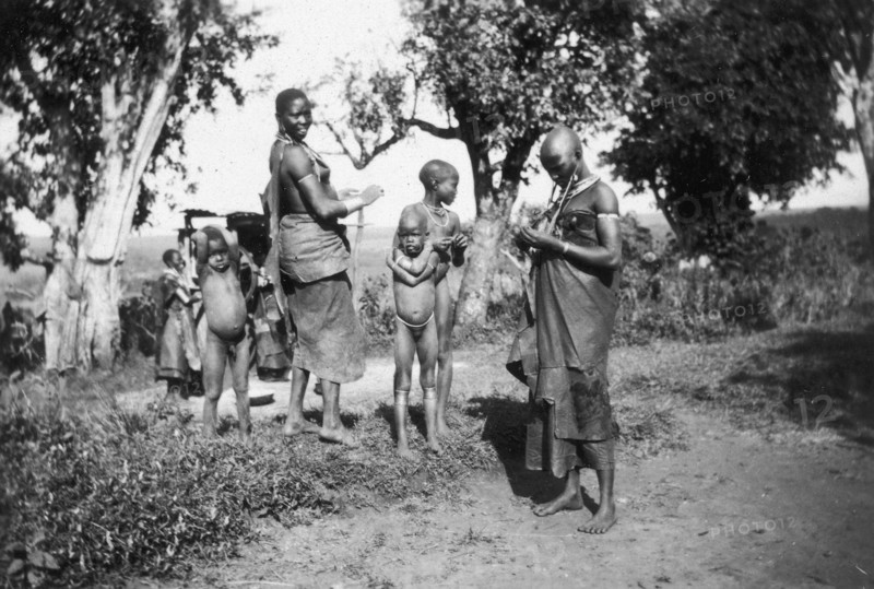 Nandi mothers and children. Nandi mothers pictured with their children in a rural setting. Near Kapsabet, Kenya, circa 1928. Kapsabet, Rift Valley, Kenya, Eastern Africa, Africa.