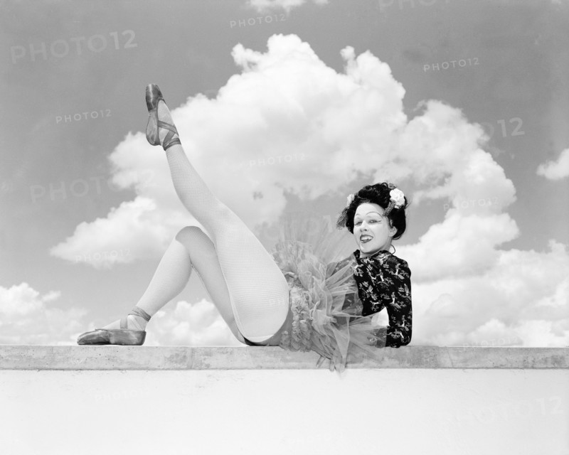 Sonja in Japanese costume. Sonja poses wearing theatrical costume comprising a tutu and ballet shoes teamed with a Japanese-style top. Her blonde hair is tucked under a dark Geisha-style wig and her oriental look is completed with theatrical make up. Kenya, 4 November 1955. Kenya, Eastern Africa, Africa.