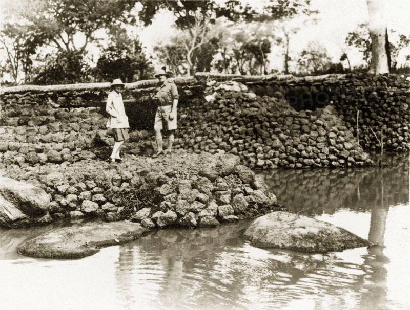 River bridge. Two European men stand on a stone bridge built in January 1928 by Captain Burges Watson over the river Bo. Sudan, circa 1930. Bo (Sudan), West Bahr el Ghazal, Sudan, Eastern Africa, Africa.