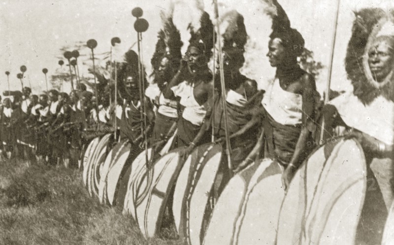 Chiefs prepare for a 'ngoma'. A group of African chiefs dressed in ceremonial costume hold sticks and patterned shields as they prepare to perform in a traditional 'ngoma'. Nairobi, Kenya, 12-17 January 1924. Nairobi, Nairobi Area, Kenya, Eastern Africa, Africa.