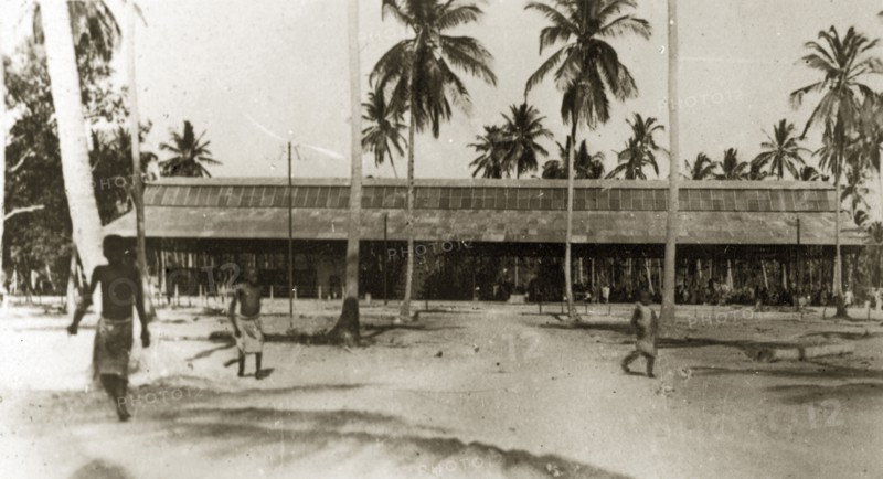Dar es Salaam market building. An African market building surrounded by tall coconut tress. Dar es Salaam, Tanganyika Territory (Tanzania), 12-17 January 1924. Dar es Salaam, Dar es Salaam, Tanzania, Eastern Africa, Africa.