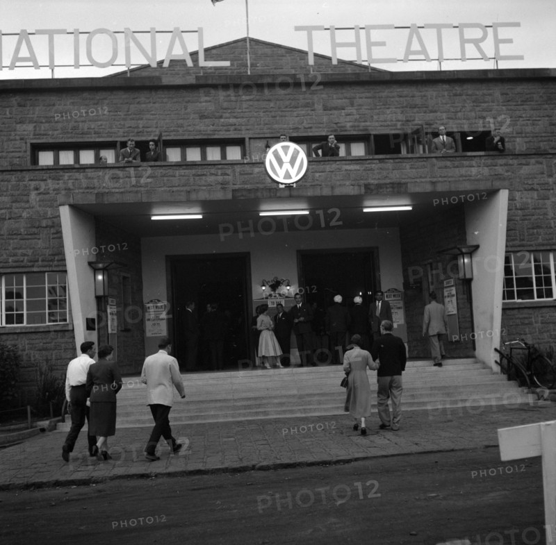 Volkswagen exhibition at the national theatre. Guests arrive for the opening of a Volkswagen exhibition being hosted inside the national theatre building. Nairobi, Kenya, 22 August 1956. Nairobi, Nairobi Area, Kenya, Eastern Africa, Africa.