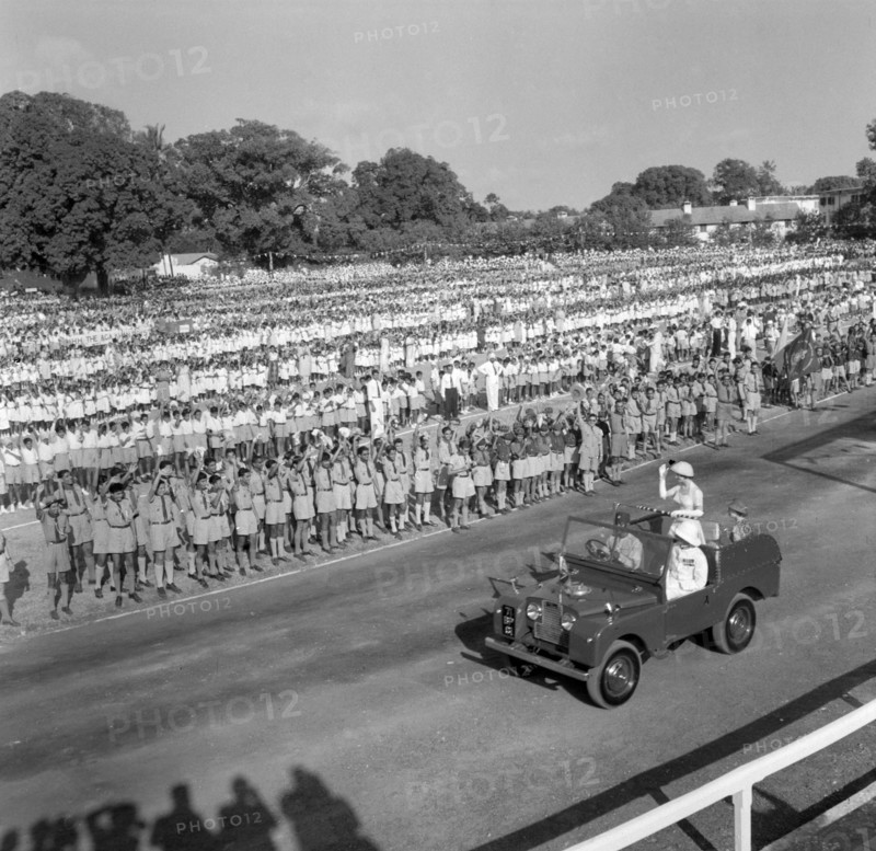 Kenyan schoolchildren welcome Princess Margaret. Princess Margaret waves to a large crowd of uniformed schoolchildren who stand in regimented lines as she is driven past them in a jeep. Mombasa, Kenya, 22 September 1956. Mombasa, Coast, Kenya, Eastern Africa, Africa.