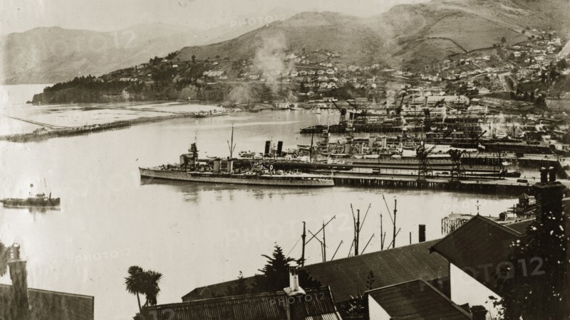 Naval ships at Lyttleton harbour. View across the harbour at Lyttleton showing the naval warships of the British Special Service Squadron docked in the bay. Lyttleton, New Zealand, 1-8 May 1924. Lyttleton, Canterbury, New Zealand, New Zealand, Oceania.