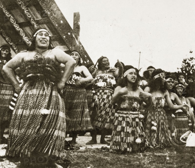 Maori singers. A group of Maori women perform a welcoming song dressed in their traditional costume of 'piupius' (woven flax skirts) and patterned 'tipares' (headbands). Rotorua, New Zealand, 10-17 May 1924. Rotorua, Bay of Plenty, New Zealand, New Zealand, Oceania.