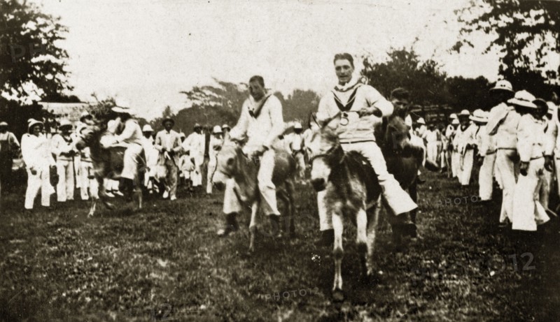Donkey derby winning post. Uniformed sailors in the British Special Service Squadron entertain their shipmates as they ride donkeys in a derby race. Chapelton, Jamaica, 26-30 July 1924. Chapelton, Clarendon, Jamaica, Caribbean, North America .