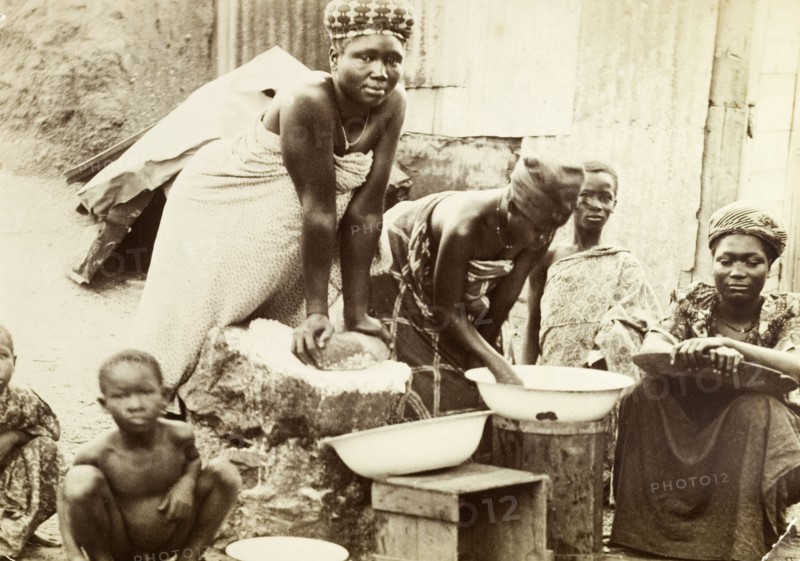 Making bread, Gold Coast. Gold Coast women making bread in a traditional manner. Salt Pond, Gold Coast (Ghana), 1918. Saltpond, West (Ghana), Ghana, Western Africa, Africa.