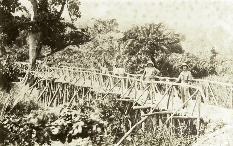 Timber bridge near Accra. Europeans and Africans pose for the camera on a timber bridge near Accra. East Gold Coast (Ghana), 1918., East (Ghana), Ghana, Western Africa, Africa.