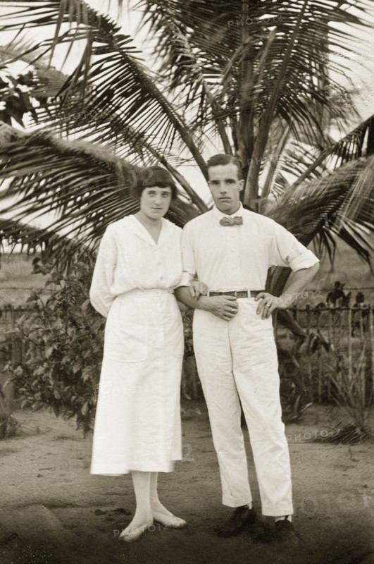 Alfred and Dorothy Tamlin. Amateur portrait of Alfred Tamlin and his wife Dorothy, nee Lamble, standing in front of a palm tree. Half Assini, Gold Coast (Ghana), May 1920. Ghana, Western Africa, Africa.