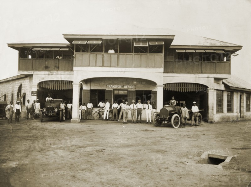 Swanzy's Motor Transport Depot. European and African staff pose with vehicles outside the Motor Transport Depot of F. & A. Swanzy Limited, a British company that traded independently on the Gold Coast from the 1820s until a company merger in 1919. Accra, Gold Coast (Ghana), 4 April 1918. Accra, East (Ghana), Ghana, Western Africa, Africa.