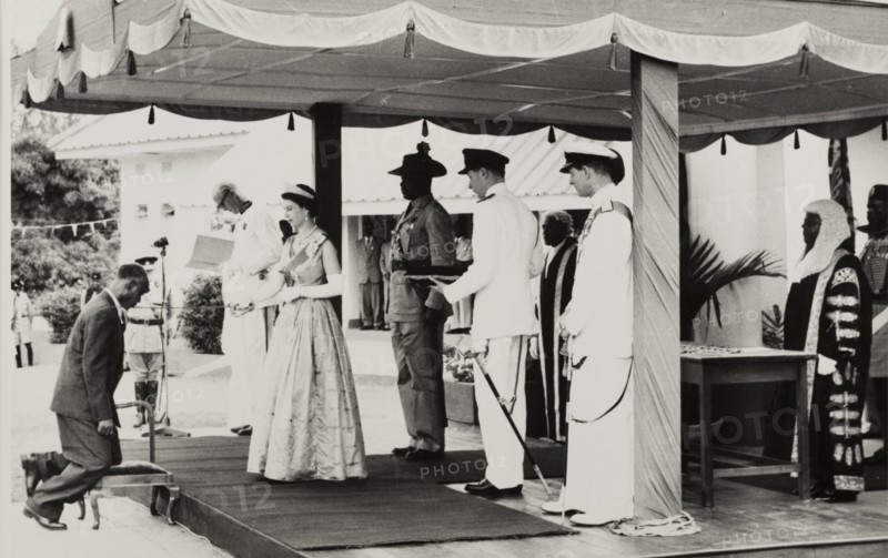 Queen Elizabeth II confers a knighthood. Queen Elizabeth II confers a knighthood on Dr Francis Ibiam of the Church of Scotland Mission, in honour of his contribution to medical services. The Queen undertook a royal tour of Nigeria with her husband, Prince Philip, Duke of Edinburgh, between 28 January and 16 February 1956. Nigeria, circa January 1956. Nigeria, Western Africa, Africa.