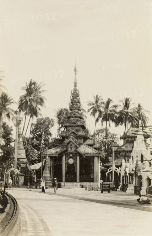 In the grounds of the Shwe Dagon Pagoda. View of a pagoda with a tiered roof and pillared entrance, located in the grounds of the Shwe Dagon Pagoda. Rangoon (Yangon), Burma (Myanmar), circa 1925., Yangon, Burma (Myanmar), South East Asia, Asia.