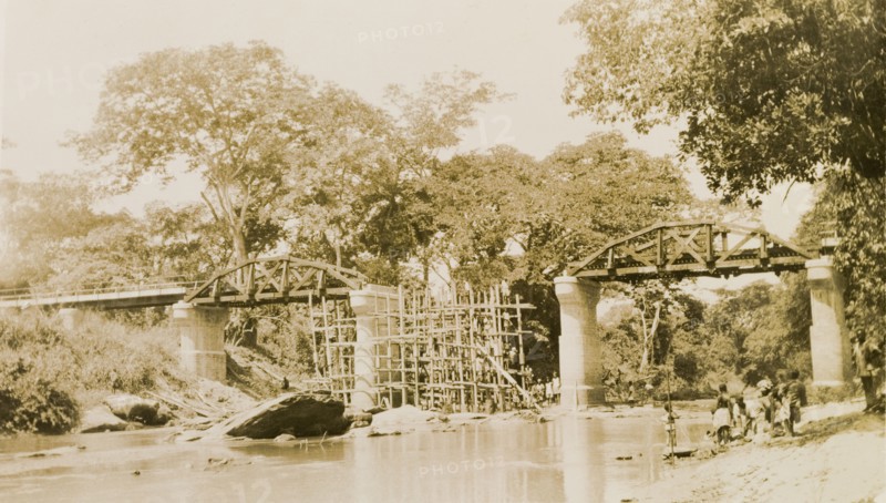The Ishua to Ibillo bridge. Scaffolding straddles a river beneath an unfinished section of the Ishua to Ibillo road bridge. Ondo, Nigeria, circa 1950., Ondo, Nigeria, Western Africa, Africa.