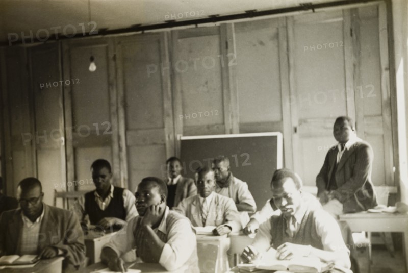 Theology students training to be priests. Theology students training to be priests attend a class at St. Paul's United Theological College in Limuru. The college was established by missionaries to train African ordinands for the priesthood and to educate their wives. Limuru, Kenya, circa 1956. Limuru, Central (Kenya), Kenya, Eastern Africa, Africa.