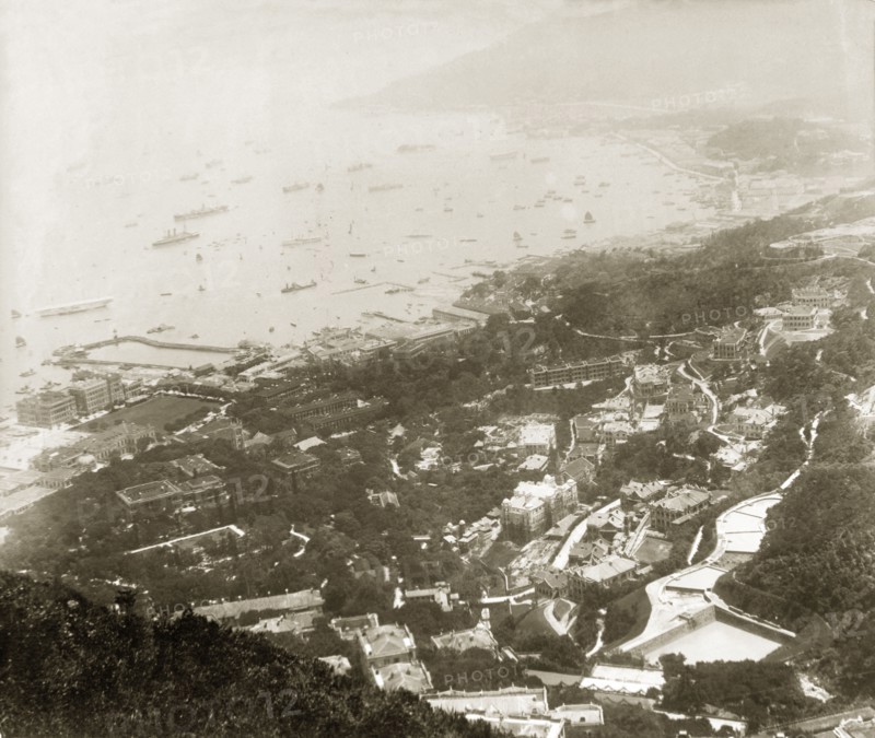 The eastern front of Hong Kong harbour. View over the eastern front of Hong Kong harbour, an area known today as 'Admiralty'. An original caption points out HMS Tamar, moored near the partially completed Admiralty Dock (centre), the Hong Kong Club (left) and the domed roof of the Shanghai Bank further inland. Hong Kong, China, 1905. Hong Kong, Hong Kong, China, People's Republic of, Eastern Asia, Asia.