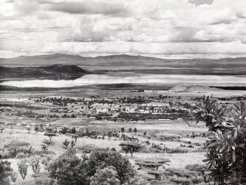View of Lake Nakuru, Kenya. Panoramic view over rolling scrubland looking towards Lake Nakuru, which the photographer notes with surprise, is full of water. Kenya, circa 1953. Kenya, Eastern Africa, Africa.