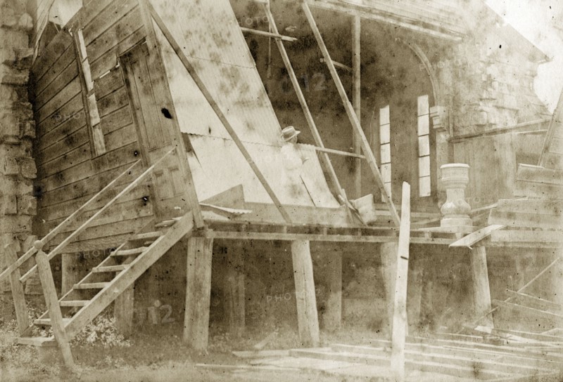 Destruction of a temporary church. A man takes notes inside the ruins of a wooden church constructed on a temporary basis for the community of Indooroopilly. The church's stone font can be seen in the wreckage. Indooroopilly, Australia, circa 1890. Indooroopilly, Queensland, Australia, Australia, Oceania.