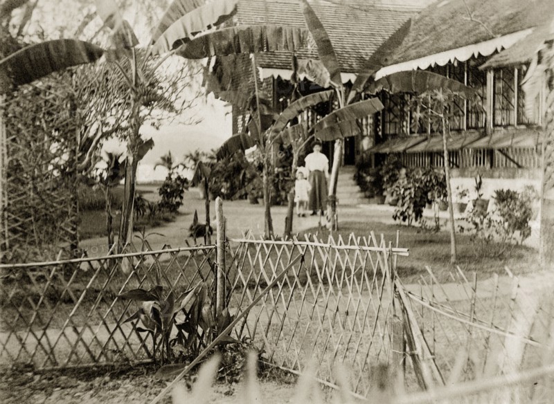 Bungalow garden on the Andaman Islands. A woman and child identified as 'Marjory and Mother' wander through cultivated gardens beside a Port Officer's bungalow. Port Blair, Andaman Islands, India, 1909. Port Blair, Andaman and Nicobar Islands, India, Southern Asia, Asia.