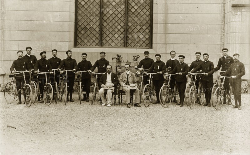 A Victorian gentlemen's bicycle group. Identified as 'The 1st Buffs' bicycle section', British cyclists in dark sports uniforms line up for a group portrait with their bicycles. India, circa 1895. India, Southern Asia, Asia.