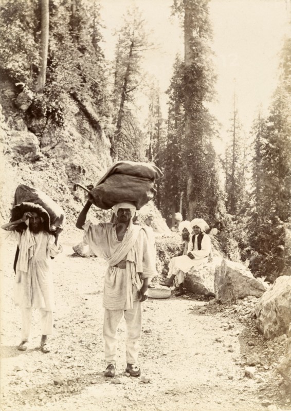 Mountain mail runners. Mail runners balance large sacks of letters on their heads as they travel along a Himalayan mountain track. India, circa 1895., Jammu and Kashmir, India, Southern Asia, Asia.