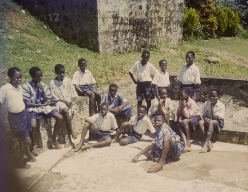 Church of Nigeria schoolboys. Uniformed boys from a Church of Nigeria school relax outdoors on a sunny day. Nigeria, circa 1964. Nigeria, Western Africa, Africa.