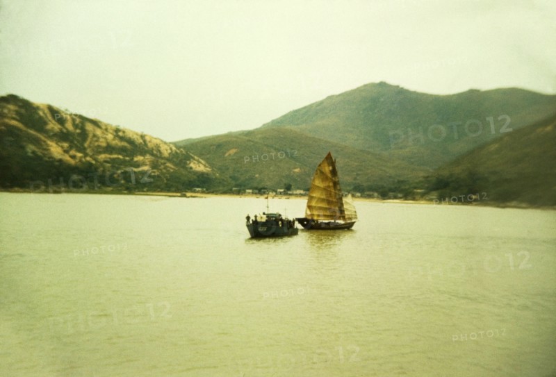 Chinese gun boat. A Chinese gun boat off the coast of Macau sails alongside a traditional Chinese junk. Macau, People's Republic of China, January 1961. Macau, Macau, China, People's Republic of, Eastern Asia, Asia.
