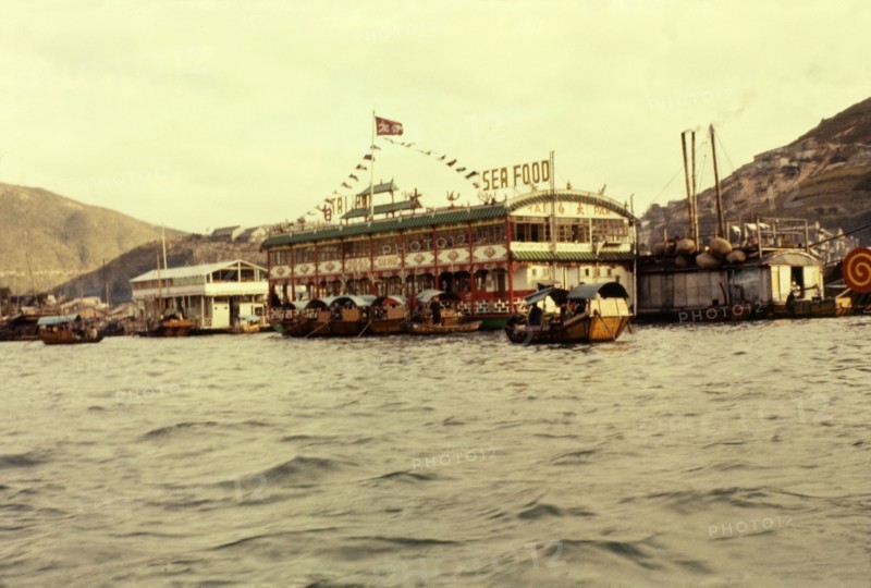 Floating seafood restaurant, Hong Kong. Sampans ferry customers across Aberdeen Bay to sample the delights of the famous Tai Bak floating seafood restaurant moored in the harbour. Aberdeen, Hong Kong, People's Republic of China, January 1961. Aberdeen, Hong Kong, China, People's Republic of, Eastern Asia, Asia.
