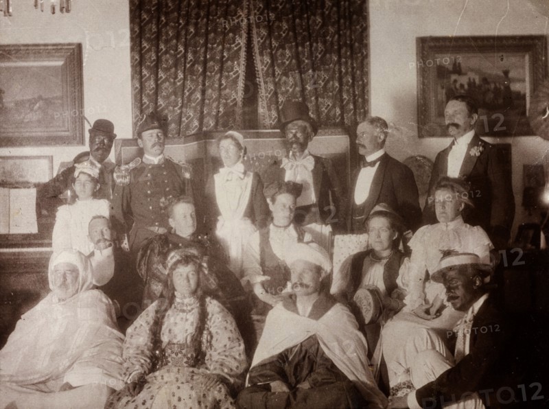 European fancy dress party, Morocco. Interior shot of European men and women dressed up in variety of Oriental and 'blacked-up' costumes. Safi, Morocco, 1898. Safi, Safi, Morocco, Northern Africa, Africa.