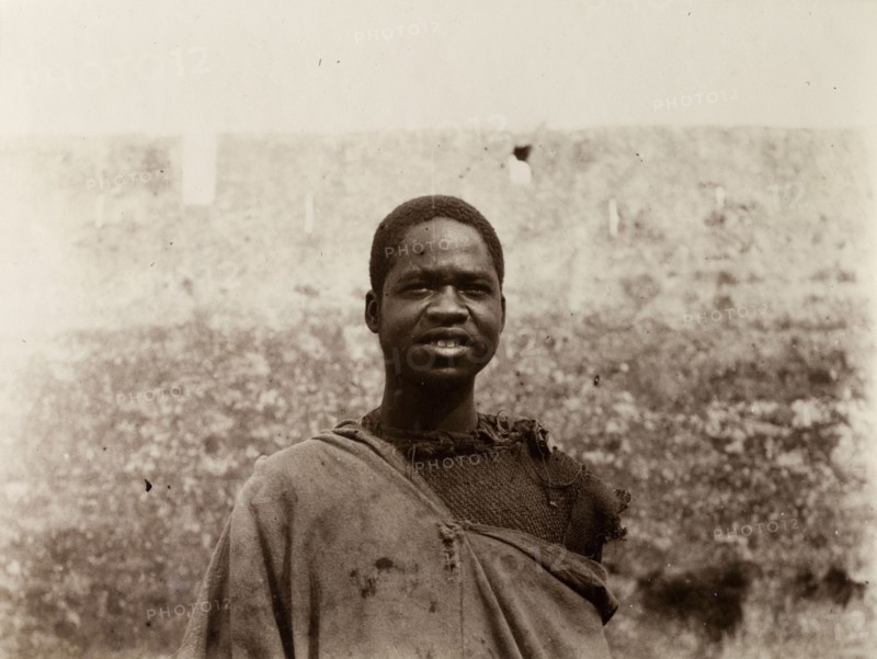 Labourer in Safi, Morocco. Outdoors portrait of a sub-Saharan African man in ragged clothing. A caption identifies him as a 'worker'. Safi, Morocco, 1898. Safi, Safi, Morocco, Northern Africa, Africa.