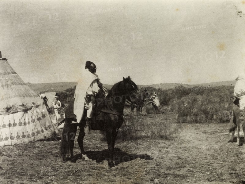 Frederick Stanbury's escort in Morocco. An African escort mounted on horseback waits to depart from a temporary camp site erected for Frederick Stanbury and his travelling party. Southern Morocco, 1898. Morocco, Northern Africa, Africa.