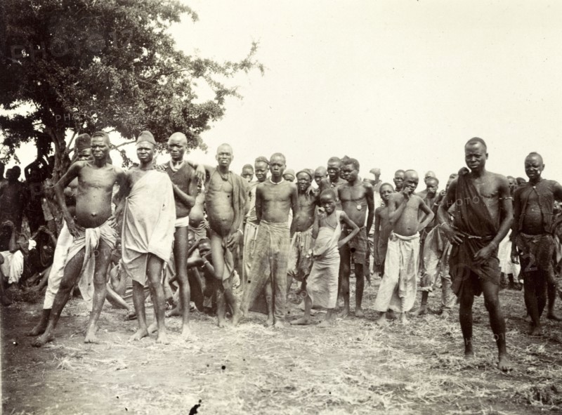 Nyamwezi porters. A crowd of male Nyamwezi porters stand, staring into the camera. German East Africa (Tanzania), 1906. Tanzania, Eastern Africa, Africa.